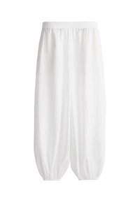 Pantalon ample en coton blanc avec taille élastique et poignets élastiques froncés aux chevilles, présenté sur un fond blanc uni.