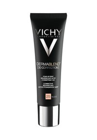 Black squeeze tube with silver cap. Features "Vichy" logo and product name in white and gold text. Label identifies shade "25 Nude."