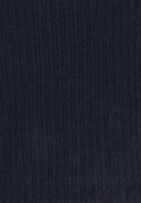 Tissu tricoté bleu foncé avec une texture côtelée. La surface présente quelques fibres claires, accentuant la profondeur et les détails du matériau.