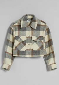 Krótka kurtka z flaneli w kremową, szarą i brązową kratę. Posiada kołnierz, zapięcie na guziki oraz dwie przednie kieszenie z klapkami. Miękka w dotyku.
