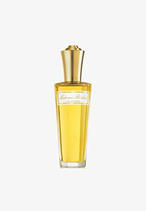 Klar glasflaske med en tilspidset form, fyldt med gul duft. Har en riflet guldhætte og en hvid etiket med sort tekst.