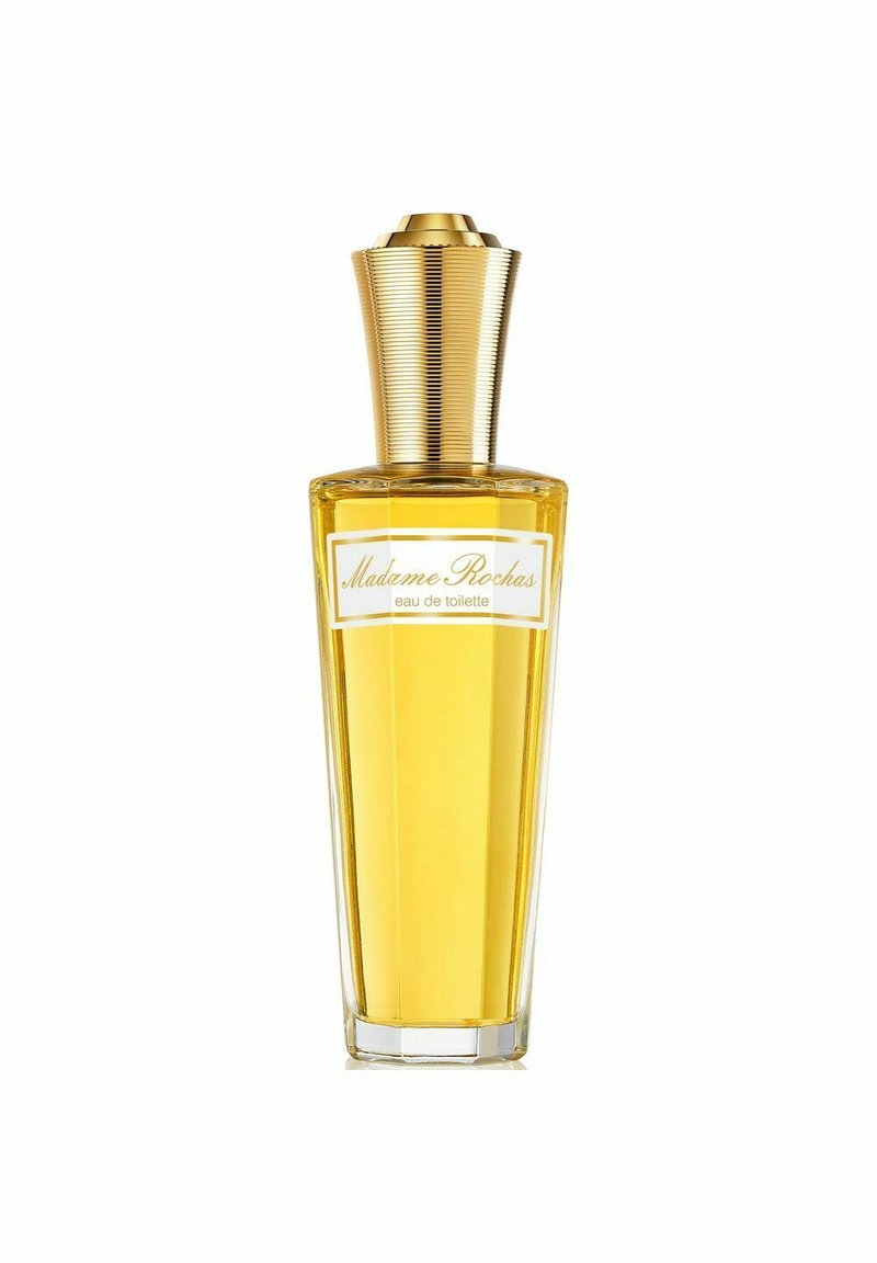 Kirkas lasipullo, kapeutuva muoto, täytetty keltaisella tuoksulla. Pullossa on uritettu kultainen kansi ja valkoinen etiketti mustalla tekstillä.