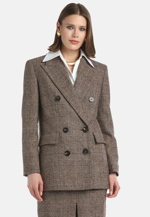 Blazer in lana doppiopetto con un motivo a quadri marrone e nero. Caratterizzato da grandi bottoni, colletto a revers e taglio strutturato.