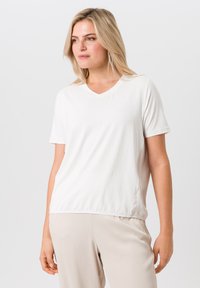 Witte katoenen V-hals t-shirt met korte mouwen, met een relaxte pasvorm en subtiele zijnaaddetails. Soepele textuur, zonder patronen.
