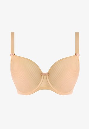 Beige gevormde bh met verticale ribbeltextuur, onderbedekking en verstelbare bandjes. Voorzien van een kleine strikaccent bij de bandbevestiging.