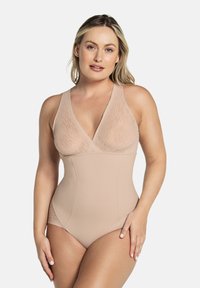 Licht beige éénstuk zwempak met een diepe V-hals, geribbelde textuur op het bovenlichaam en een gladde onderkant. Atletische snit met brede bandjes.