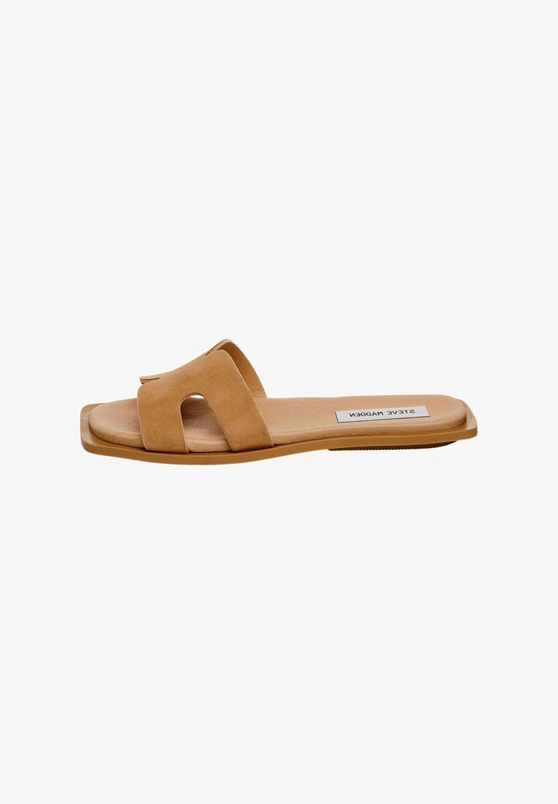 Tan suede slide sandal featuring two wide straps with cut-out details, flat sole, and subtle logo on the insole.
