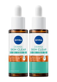 Two clear glass bottles of NIVEA Derma Skin Clear serum, featuring a white dropper and labels in blue and orange, highlighting key ingredients.