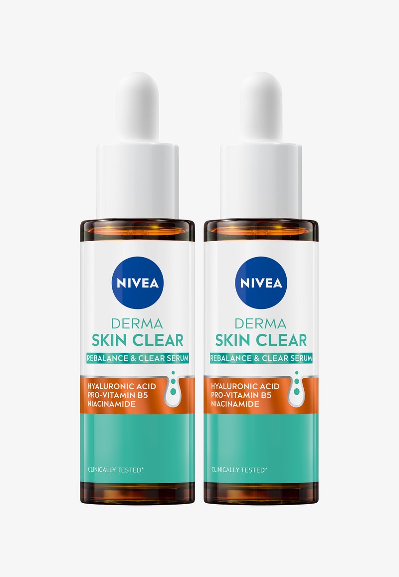 Two clear glass bottles of NIVEA Derma Skin Clear serum, featuring a white dropper and labels in blue and orange, highlighting key ingredients.