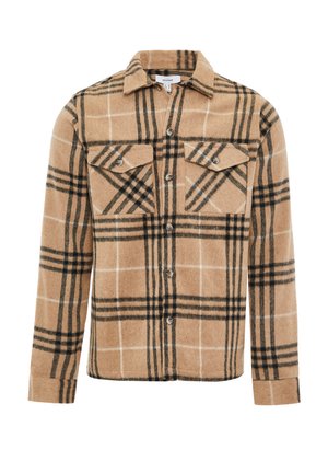 Chemise en flanelle à carreaux bruns avec des lignes noires et blanches. Comprend deux poches sur la poitrine, une fermeture à boutons et un ourlet arrondi. Le tissu a une texture douce.