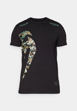 Black cotton t-shirt featuring a large camouflage graphic and "Venum" text in green on the shoulders. Short sleeves, standard fit.