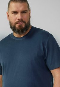 T-shirt blu scuro a maniche corte realizzato in cotone liscio, con scollatura rotonda e senza motivi o accenti visibili.