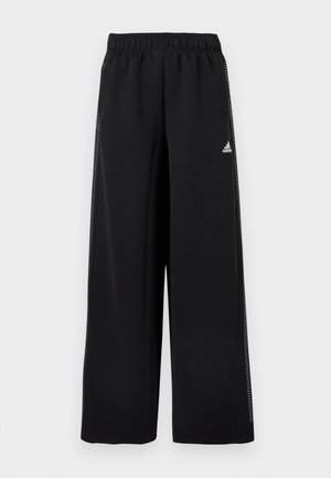 Čierne športové nohavice so širokým strihom nohavíc, elastickým pásom a dekoratívnymi bielymi pruhmi po stranách. Vyrobené z mäkkého, elastického materiálu.