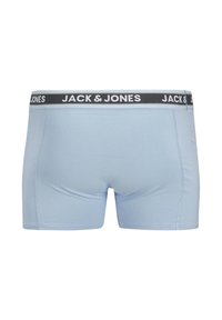 Light blue boxer shorts made of smooth fabric featuring a black waistband with white logo text, designed for a fitted silhouette.