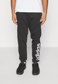 adidas Sportswear - Treniņtērpa apakšdaļas - black Miniatūras attēls 1