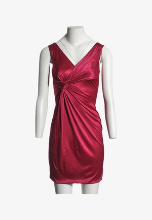 Robe rouge en satin sans manches avec col en V et détail de nœud à l'avant, présentée sur un mannequin blanc sans tête sur fond blanc.