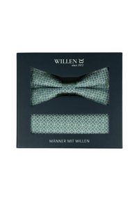 Grün gemusterte Fliege und passendes Einstecktuch in einer schwarzen Schachtel mit der Aufschrift "WILLEN seit 1972." Die Muster sind diamantförmig mit dezenten Akzenten.