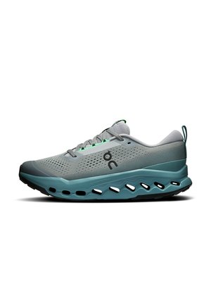 Light grey athletic shoe with teal accents, mesh upper, lace closure, and a thick teal sole featuring oval-shaped cutouts along the side.