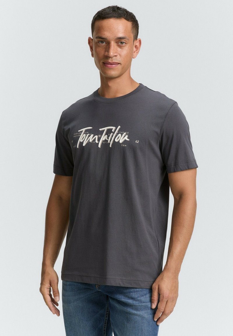 Tricou din bumbac gri închis, cu guler rotund, mâneci scurte și un print grafic alb pe față cu textul "Tom Tailor."