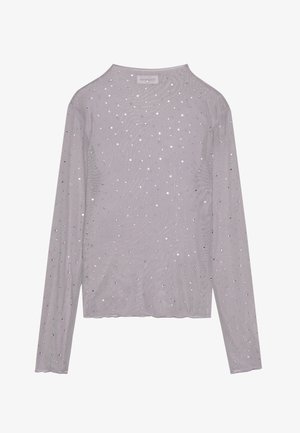 Top gris à manches longues en tissu léger et texturé. Il présente un motif à pois avec des accents argentés partout. Encolure arrondie.