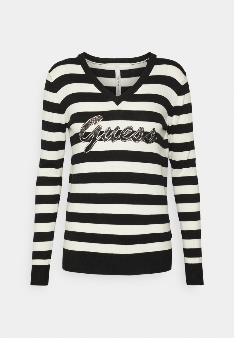 Pull rayé noir et blanc avec un col en V, orné d'un logo "Guess" en strass à l'avant. Manches longues et poignets côtelés.