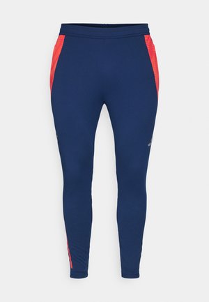 Marineblauwe leggings van een rekbare stof met rode zijpanelen en een aansluitend ontwerp. Voorzien van een stevige tailleband en subtiele logo-detail.
