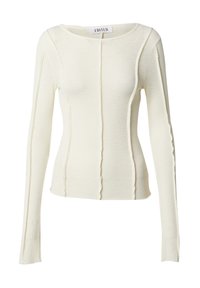 Langdurige top van zacht, off-white ribgebreid materiaal. Heeft subtiele naaddetails en een aansluitend ontwerp, met een ronde halslijn.