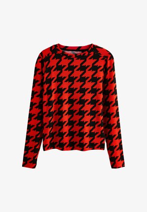 Haut à manches longues rouge avec un motif pied de poule noir, fabriqué en tissu doux, doté d'un col rond et d'une coupe décontractée.