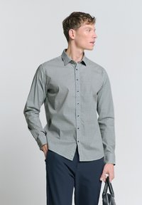 Overhemden met een geruit patroon in verzacht groen, met een kraag, lange mouwen en een slim fit. Katoenen stof met een gladde textuur.