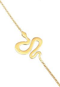 Gul ormformad armband med en slät, glänsande yta. Har en kedjeleddesign som kopplar samman vid båda ändar till ormsymbolen.