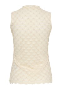 Haut sans manches en dentelle crème avec bords festonnés et motif éventail répétitif sur le tissu.