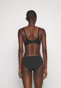 Black underwear set featuring a bra with adjustable straps and a clasp back, paired with high-waisted bikini-style bottoms. Smooth texture.