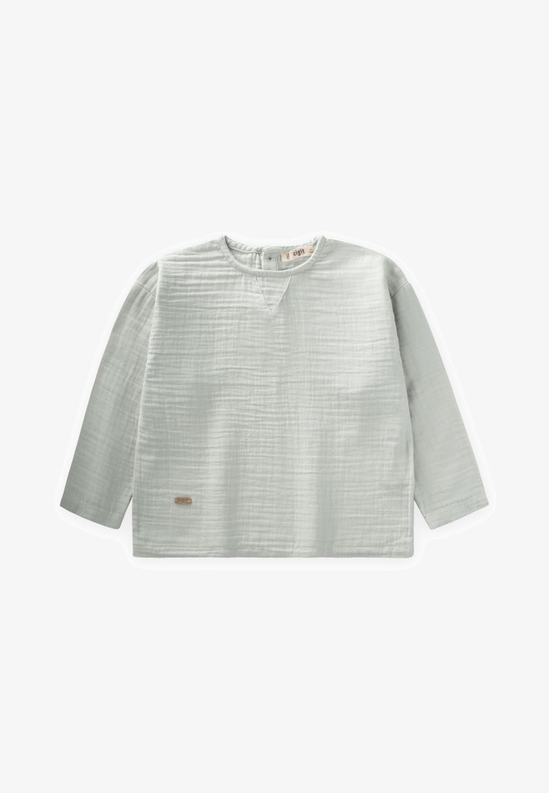 Pilk šviesiai pilkas ilgomis rankovėmis viršus iš tekstūruoto audinio. Turi V formos iškirptę ir mažą etiketę apatinėje pusėje, su laisvu siluetu.