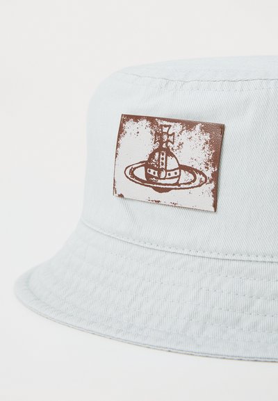 Light blue bucket hat made of cotton, featuring a textured finish and a brown leather patch with a space-themed graphic.