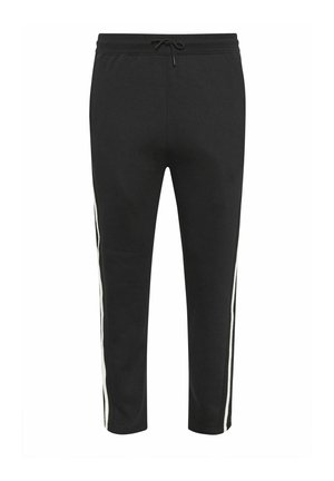 Pantalon de survêtement noir fuselé avec des bandes blanches sur les côtés et une taille à cordon, présenté sur fond blanc.