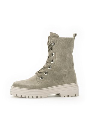 Green suede ankle boot with round toe, lace-up front, metallic eyelets, and chunky white sole featuring a textured tread.