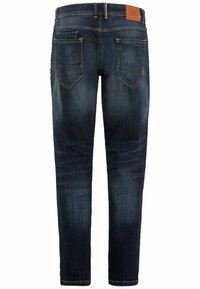 Mørkeblå denim jeans med fem lommer, synlige sømme og et læderpatch-label på taljebåndet. Tajt design, let falmet.
