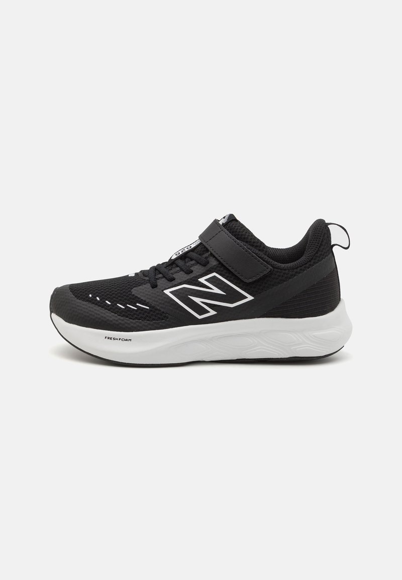 Chaussure de sport noire avec une tige en mesh, accents blancs, une sangle à boucle auto-agrippante et une semelle blanche rembourrée avec des motifs texturés.