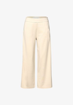 Laajalahkeiset kermaan beigehousut, joissa on kuminauhavyötärö, tehty pehmeästä kankaasta, esitetty valkoista taustaa vasten.