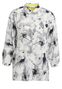 Chemise à manches longues boutonnée avec imprimé floral abstrait noir et gris sur tissu blanc et doublure de col jaune pâle.