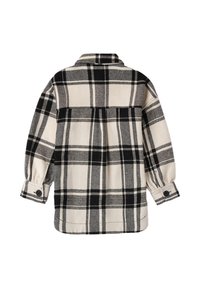 Plaid shirt with a cream and black pattern, soft fabric, buttoned cuffs, and a relaxed fit. Features a collar and back yoke detail.