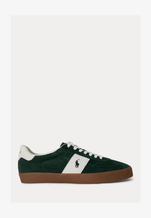 Madalad tumesinised seemisnahast tennised valge nahast detaili, valgete paelte, pruuni kummist tallaga ja musta polo mängija logoga küljes.