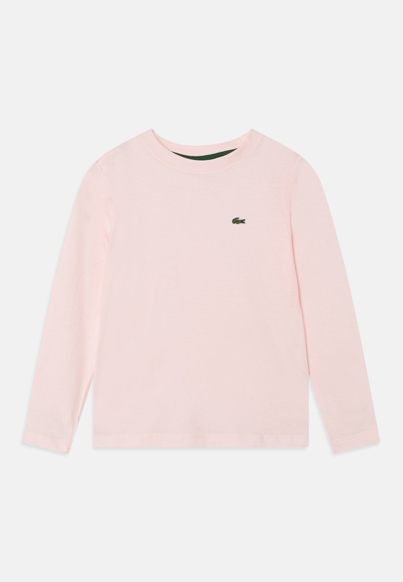 Světle růžová dlouhá rukávová košile vyrobená z bavlny. Má kulatý výstřih a malou zelenou logo Lacoste na hrudi. Jednoduchý design.