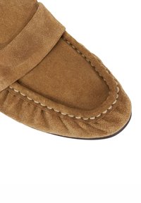 Brown suede moccasin with a square toe, featuring a decorative stitched edge and gathered detail along the side. Soft texture and simple design.