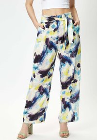 Wide-leg pants featuring a watercolor abstract pattern in blue, purple, and yellow. Made from lightweight fabric with a tie belt and pockets.