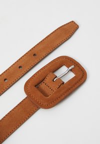 Brown suede belt with rectangular metal buckle, featuring a textured finish and evenly spaced holes for adjustments.