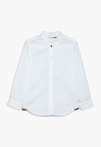 Valkoinen pitkähihainen paita, jossa on nappikaulus, pyöristetty helma ja värikkäät yksityiskohdat sivusaumoissa. Sujuva pinta, puuvillamateriaali.