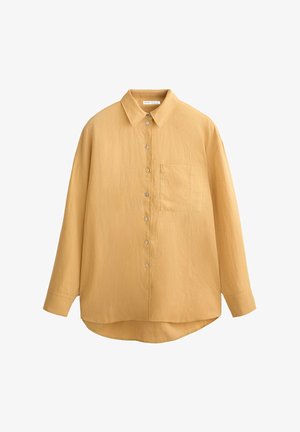 Mustard yellow button-up shirt with a collar, long sleeves, textured fabric, and a single chest pocket; rounded hem and shell buttons.