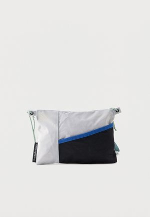 Rectangular sling bag with light gray and black panels, blue diagonal trim, mint green adjustable straps, and a black label reading "Peak Performance."