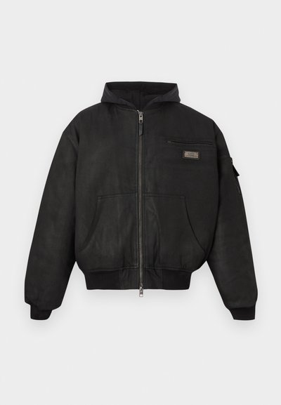 Μαύρο μπλούζα bomber από λείο ύφασμα, με φερμουάρ μπροστά, κουκούλα και δύο εμπρόσθιες τσέπες με φερμουάρ στο στήθος.